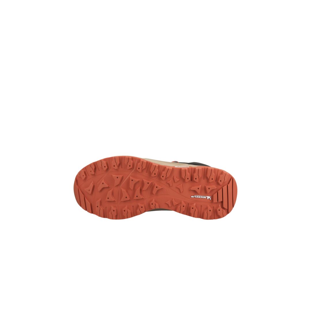 A single Halti Hiker Kuru DrymaxX Womens outdoor shoe sole in red-orange with textured treads on a white background.