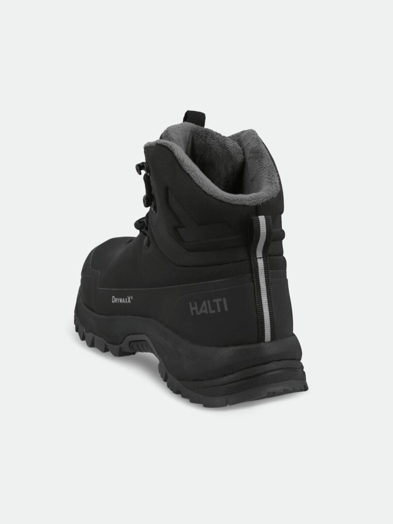 The Halti Nuuksio Mid 2 DX men's outdoor shoe in black with rugged sole and grey fleece, shown from back left angle.