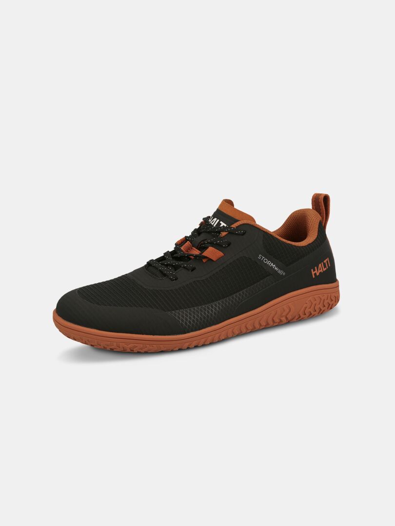 Halti Tuntuma barefoot shoe in black/brown, water-resistant with black laces, orange sole, and branded tongue/heel.
