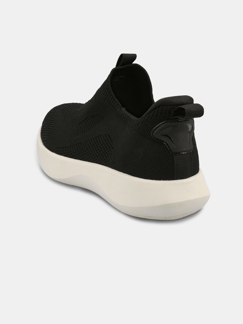 The Halti Snabb 2 StepIn Men's Sneaker is black with a white sole, mesh upper, and pull tabs, shown from the back.