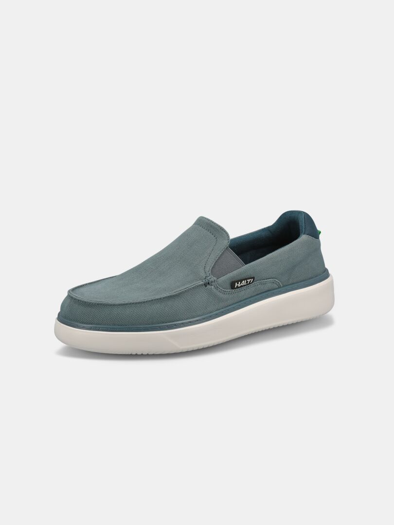 The Halti Lido Canvas Shoe Men's, a single blue loafer with a white sole, is shown on a plain white background.