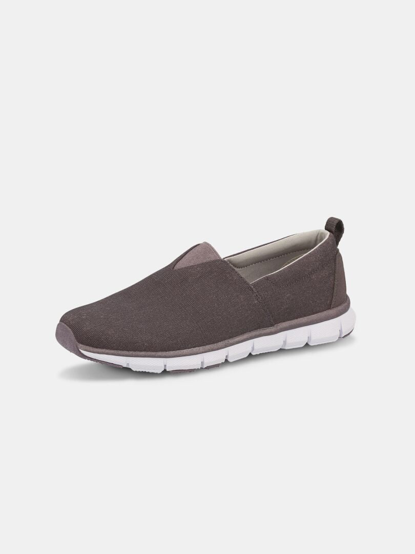 The Halti Lente Canvas Shoe Women's is a brown slip-on loafer with a white rubber sole, shown on a plain white background.
