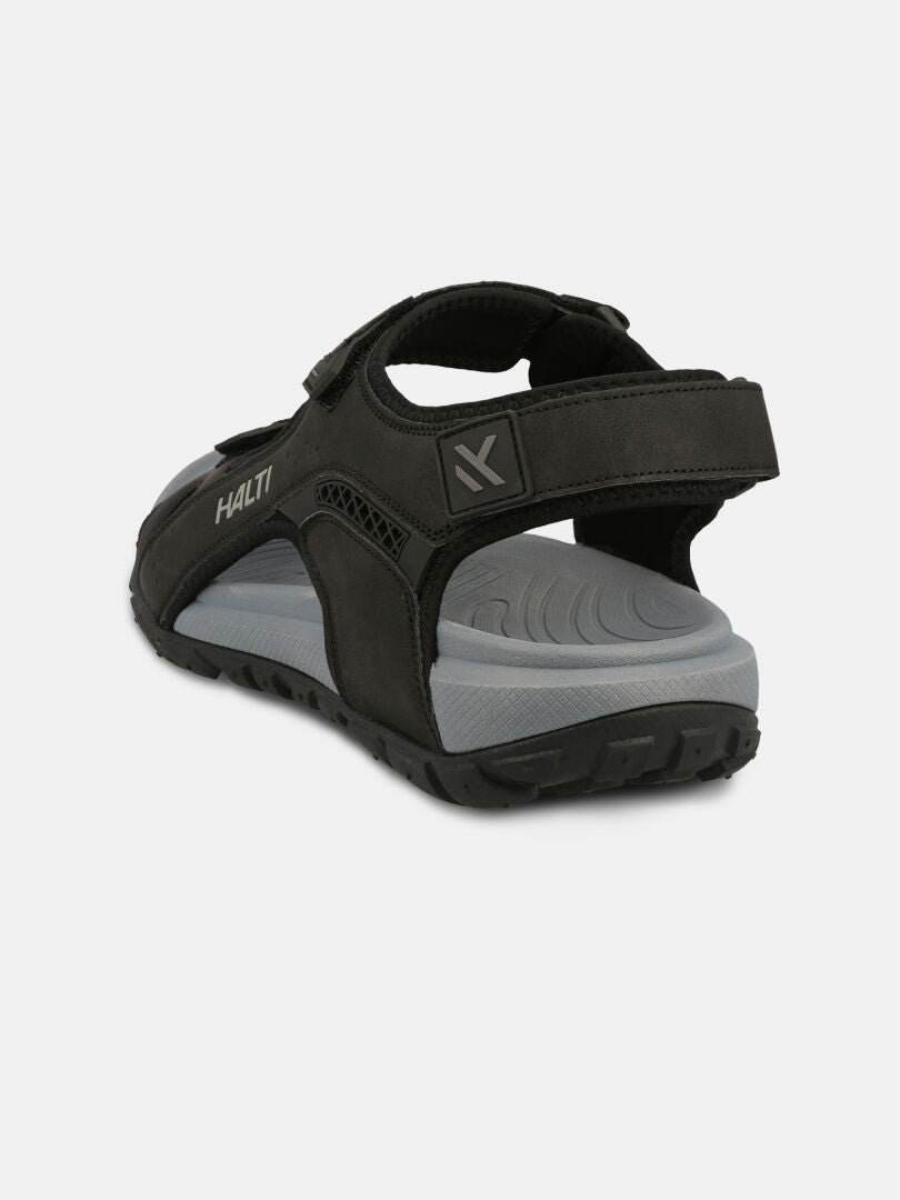 The Halti Route 2 Sandal in black/gray features a thick sole, ergonomic footbed, and Velcro straps, back left view.