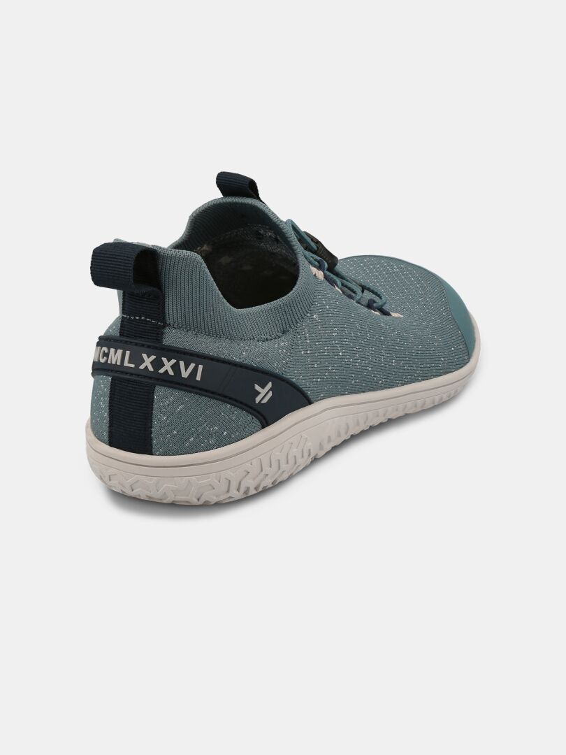 The Halti Vire Barefoot Shoe Men's is teal with white speckles, pull tab, and MCMLXXVI on the heel.