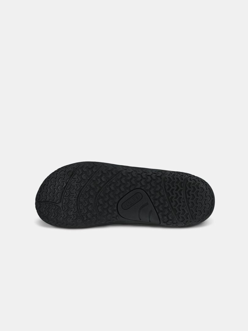 The Halti Tuntuma DX Barefoot Shoe Men's features a black textured zero-drop rubber sole with a detailed tread pattern.