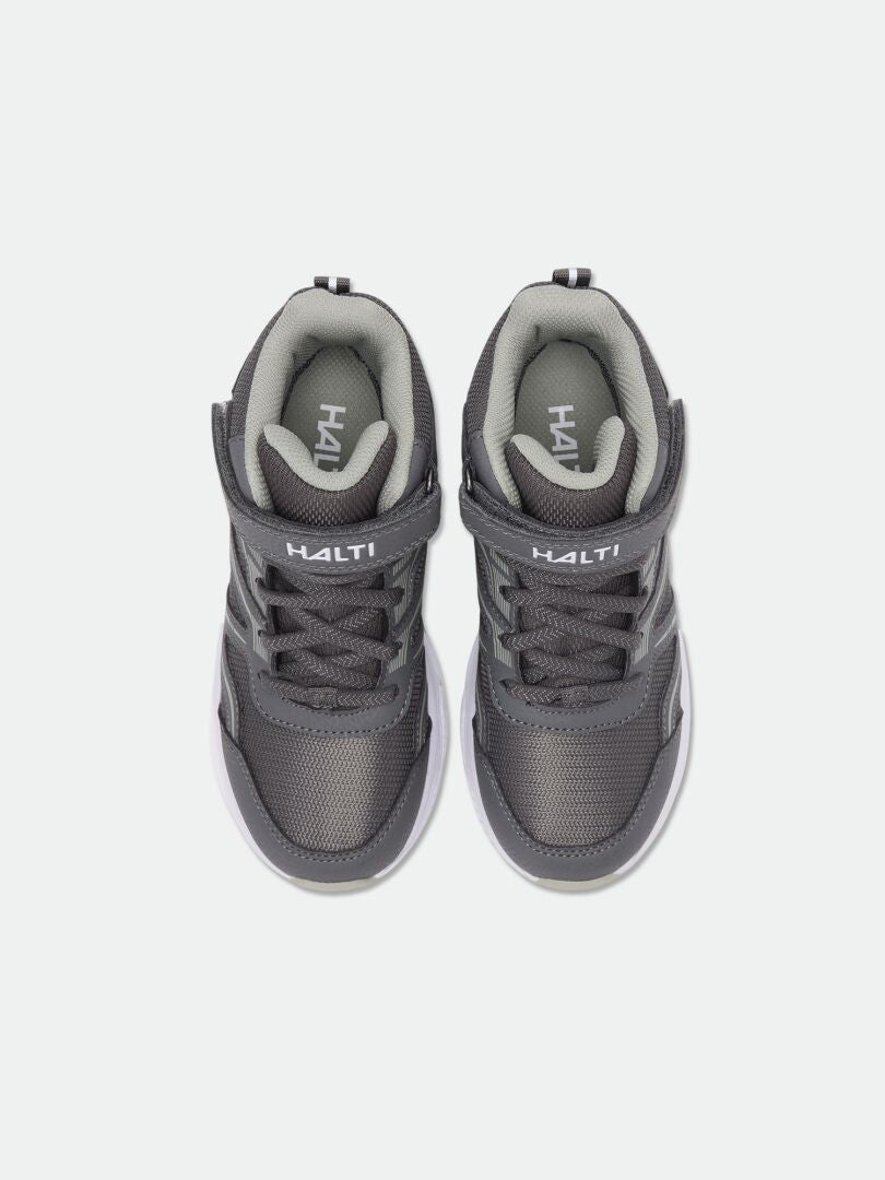 Gray Halti Zuma Mid DX kids’ sneakers with laces and Velcro, top view on a white background.