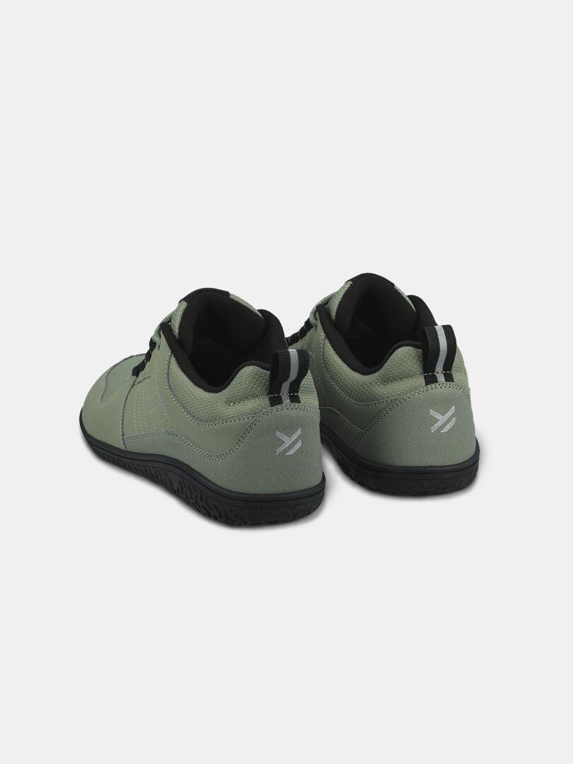 Halti Tuntuma DX women's barefoot shoes in light green with black soles and striped pull tabs, back view on white.