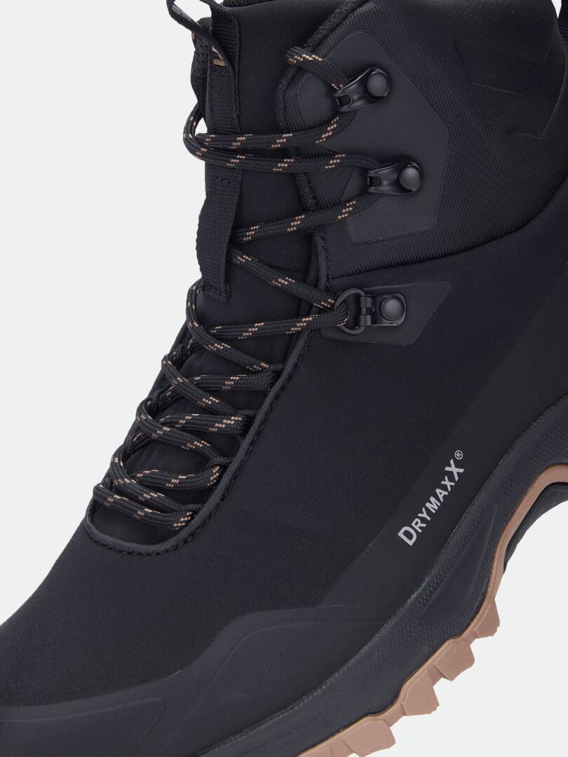 Close-up of Halti Fara Mid 4 DX men’s black outdoor shoe with brown tread, DRYMAXX, and waterproof trail traction.