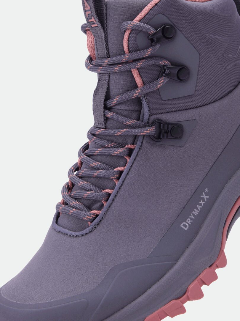 Close-up of Halti Fara Mid 4 DX women’s outdoor shoe in purple with pink laces, Drymaxx® logo, and GripmaxX Trail outsole.