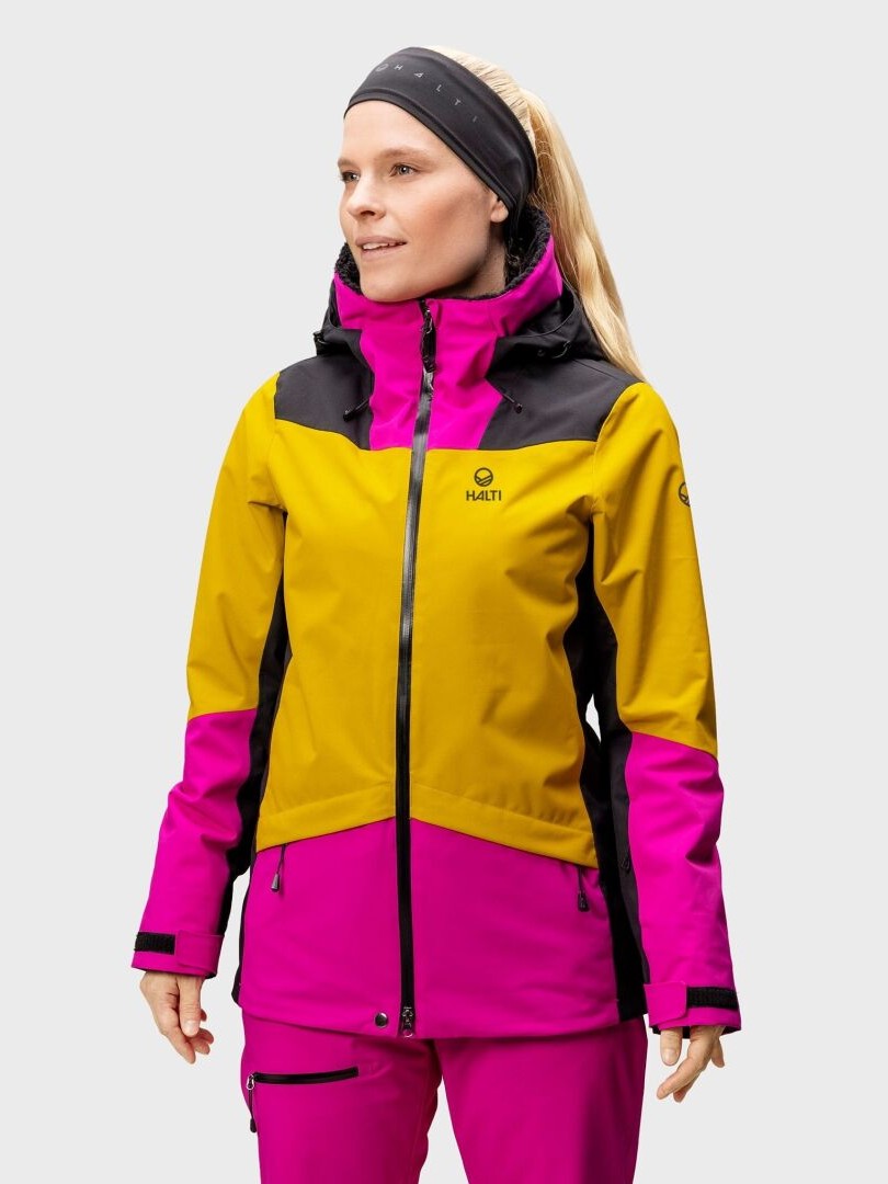 A person wears the Halti Planker DrymaxX Women's Ski Jacket in yellow and magenta, plus a black headband, plain background.