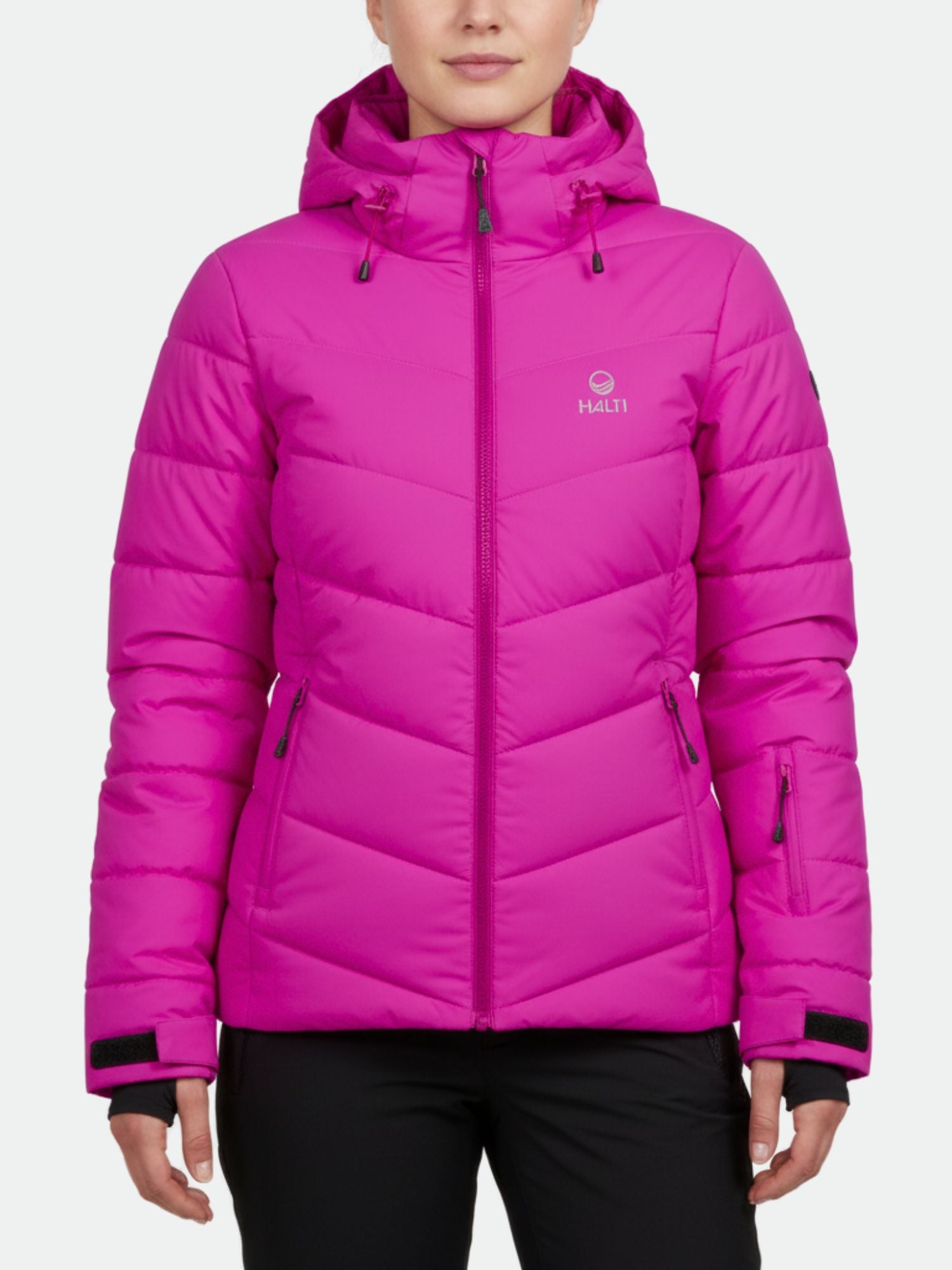 A woman wears the Halti Mellow Puffer Ski Jacket Womens in bright pink with thermal insulation against a white background.
