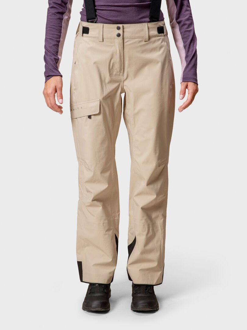 Person wearing Halti Settler 3L DrymaxX Womens ski pants, black suspenders, black boots, and a purple long-sleeve shirt.