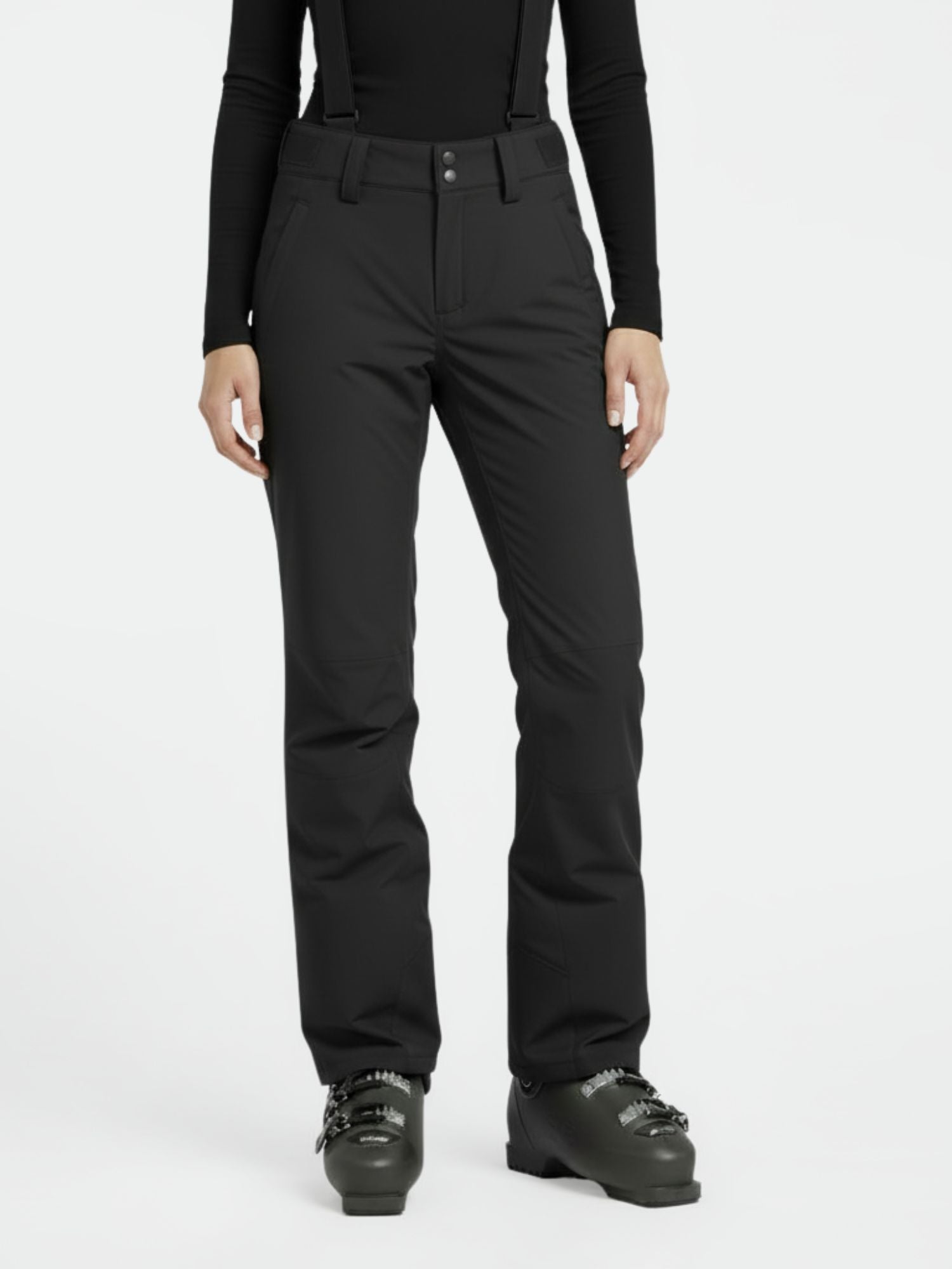 Model wears Halti Trusty DrymaxX Ski Pants for women, black top, and ski boots against a plain white background.