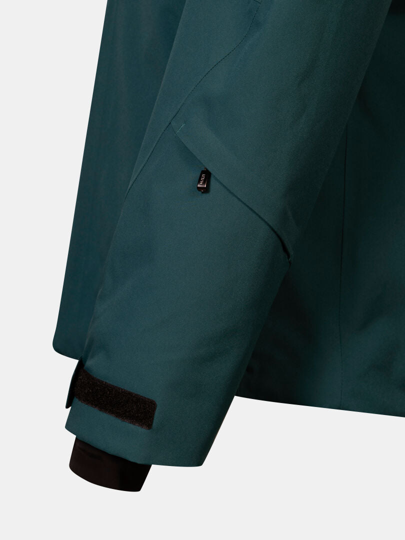 Dark teal waterproof sleeve of a Halti Vertica DX Ski Jacket featuring a zippered forearm pocket and adjustable cuff.