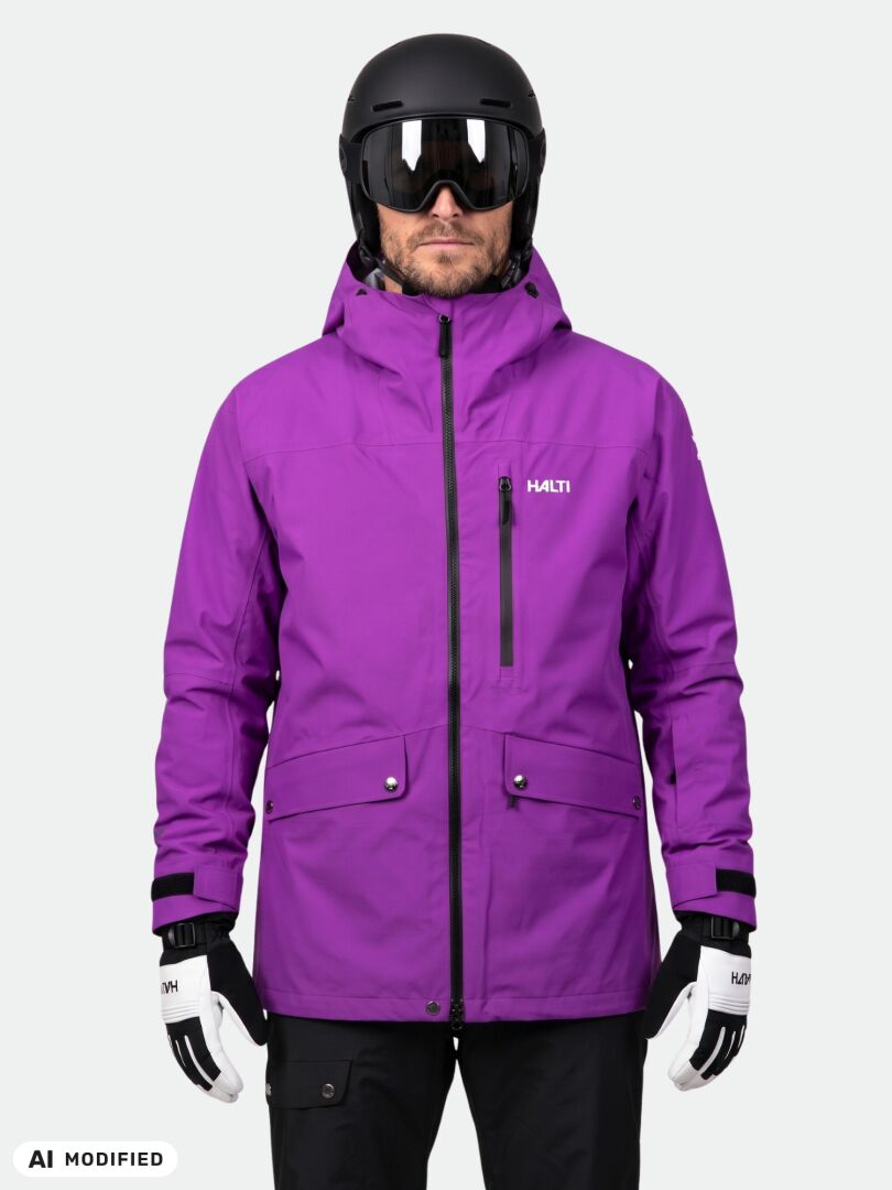 A man in a purple Halti Settler 3L DX Ski Jacket Men’s, black helmet, goggles, and gloves.