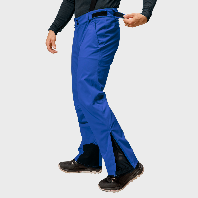 Man adjusts waist strap of Halti Trusty DrymaxX Ski Pants in bright blue, shown from shoulders down.