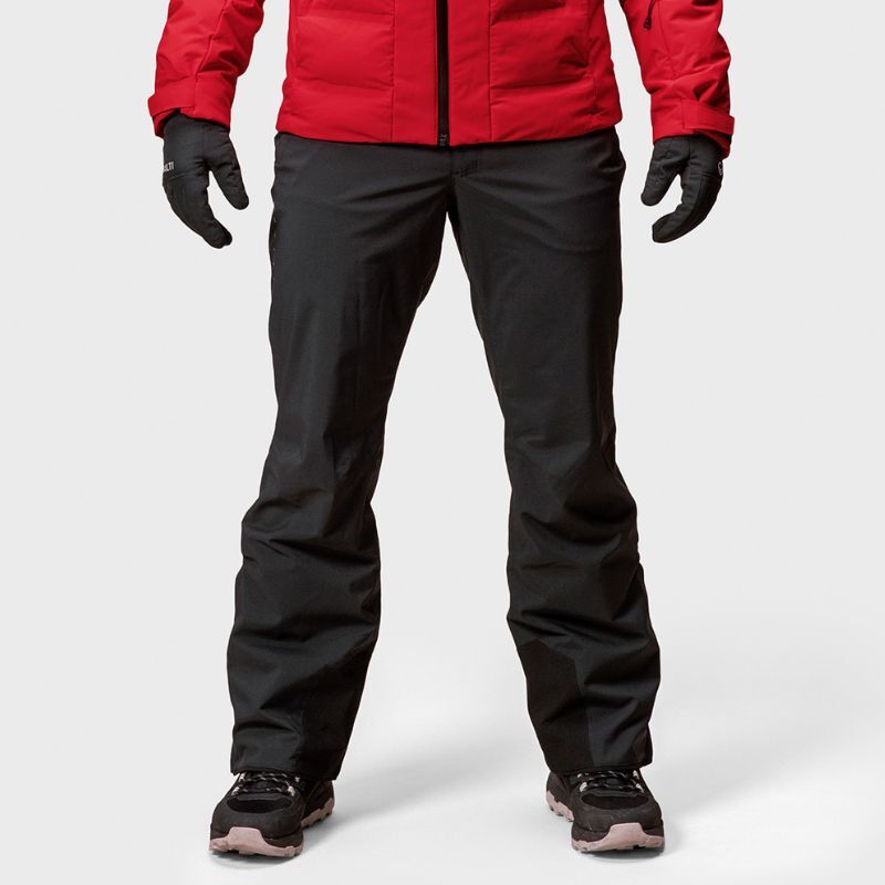 A person in Halti Trusty DrymaxX Ski Pants for men, a red jacket, and gloves stands against a plain background.