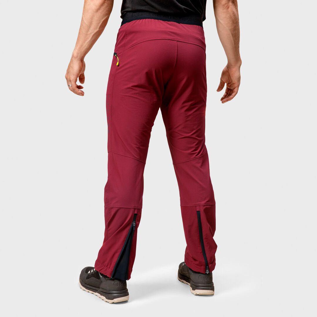 A person wears Halti Adrenaline Lite Ski Touring Pants Mens in maroon, shown from the back against a plain light background.