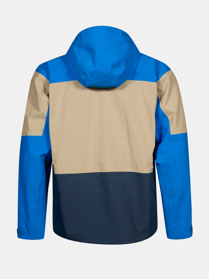 The Halti Rizle 3L DX Ski Jacket Unisex features blue, beige, and navy color-block panels with a hood, shown from the back.