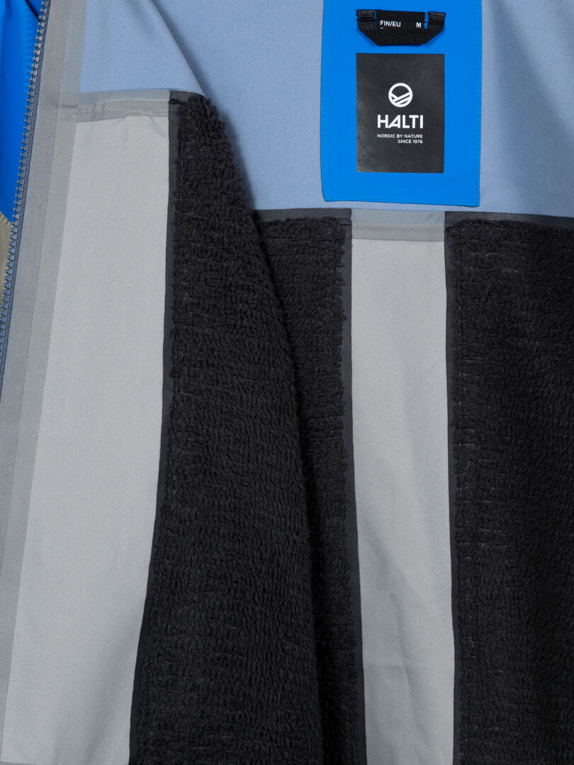 Close-up of Rizle 3L DX Ski Jacket’s interior with Primaloft fleece, light gray seams, and a blue Halti tag.