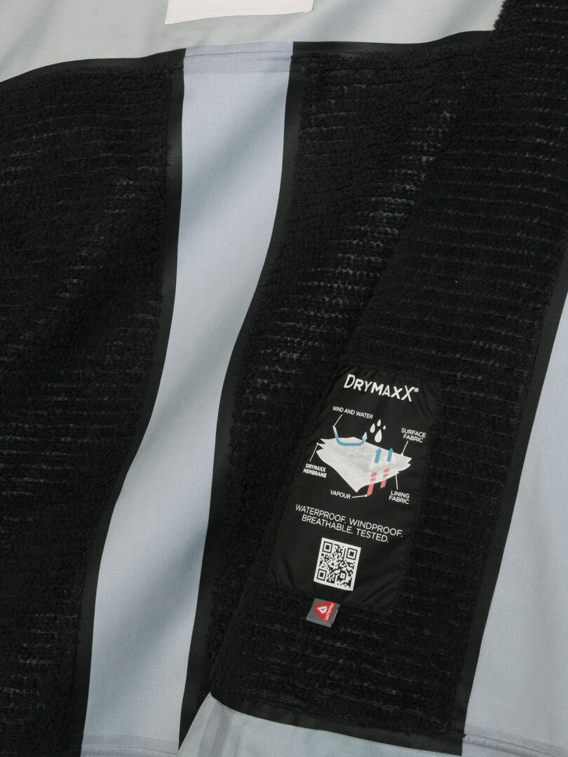 Interior of a Rizle Unisex 3L DX Ski Jacket showing a label with material layers and a QR code.