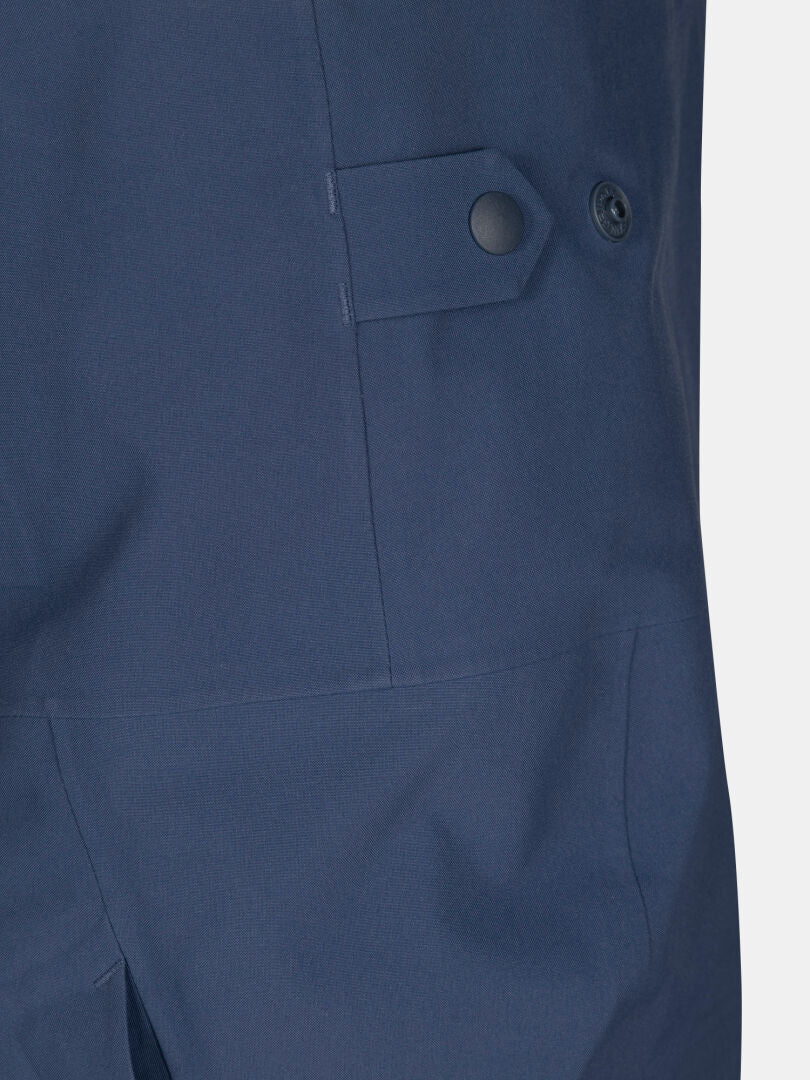 Close-up of Halti Rizle 3L Dx Unisex Ski Pants in navy blue with side flap and snap button detail.