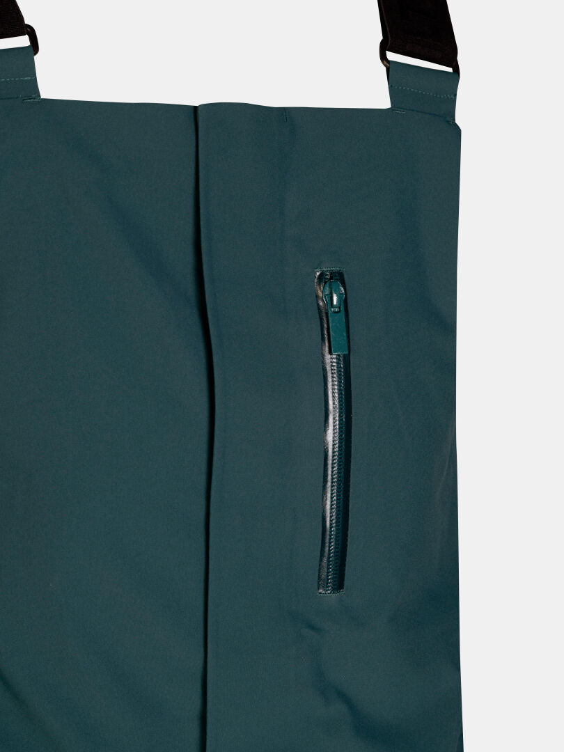 Dark teal Halti Rizle 3L Dx Ski Pants Unisex with a zippered chest pocket and adjustable black shoulder straps.