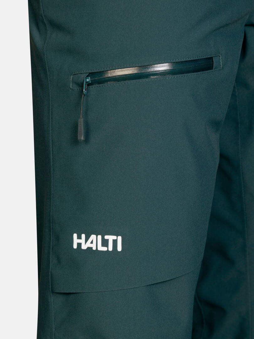 Dark green Halti Carvey II DX Ski Pants women’s waterproof pants with a zippered pocket and a logo near the hem.