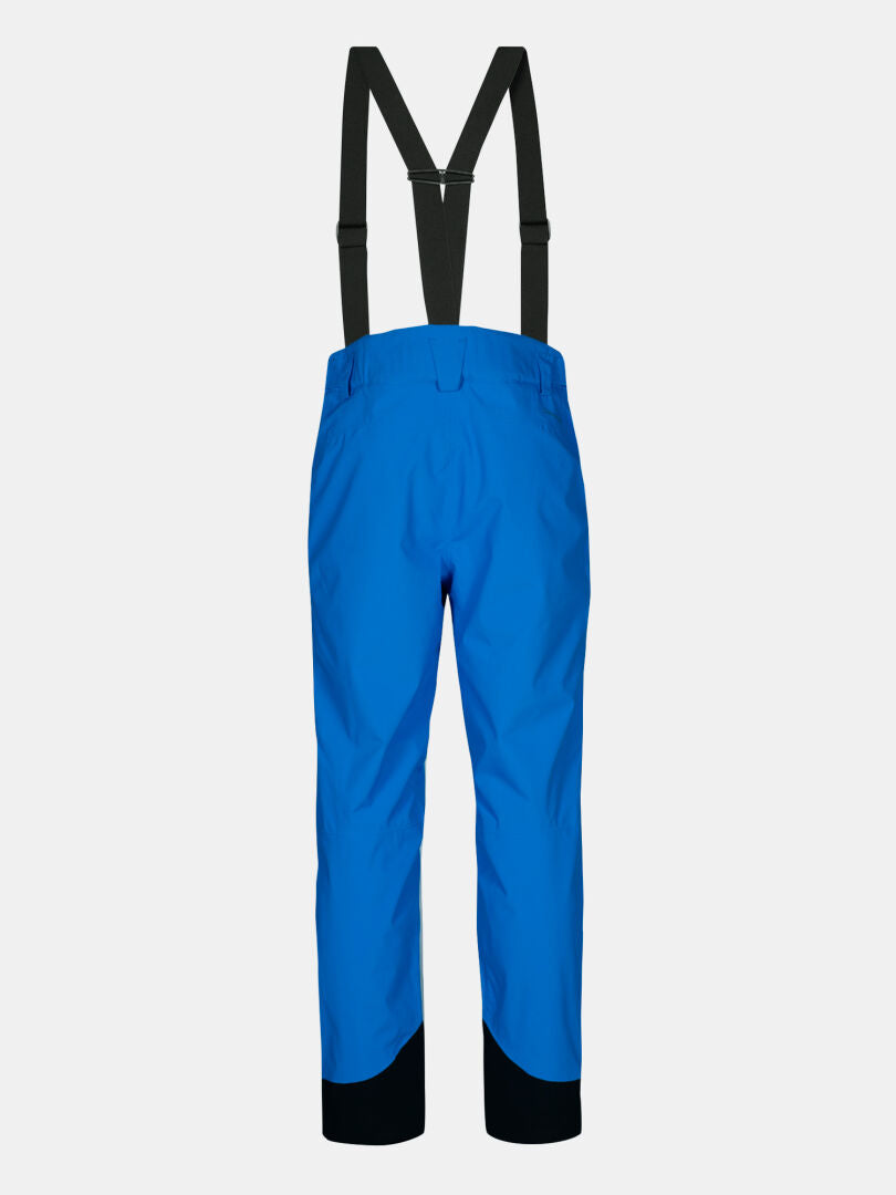 Halti Carvey II DX Men's ski pants in bright blue with black suspenders and reinforced cuffs, shown from the back.