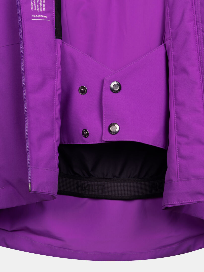 Interior of the purple Halti Melvik DX Ski Jacket Women’s showing the powder skirt with snap buttons and elastic waistband.