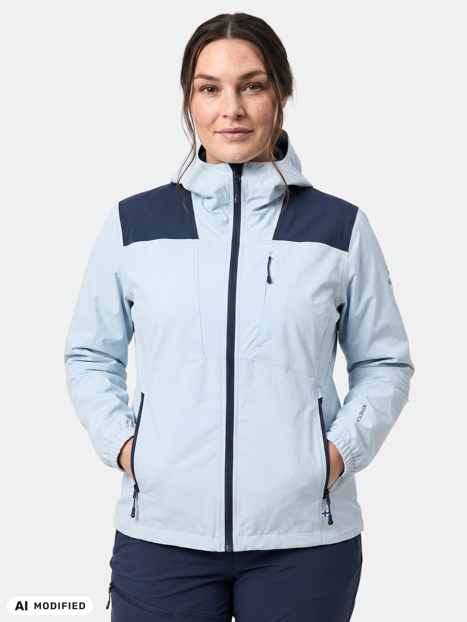 Model in Halti Pallas II X-stretch Jacket Women's Plus, hands in pockets, facing forward on white background.