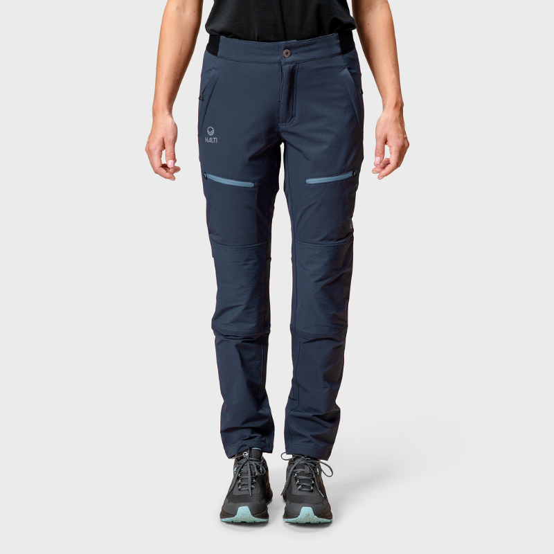 Model wears Halti Pallas II Womens Warm X-stretch Pants in navy blue, standing against a plain light background.