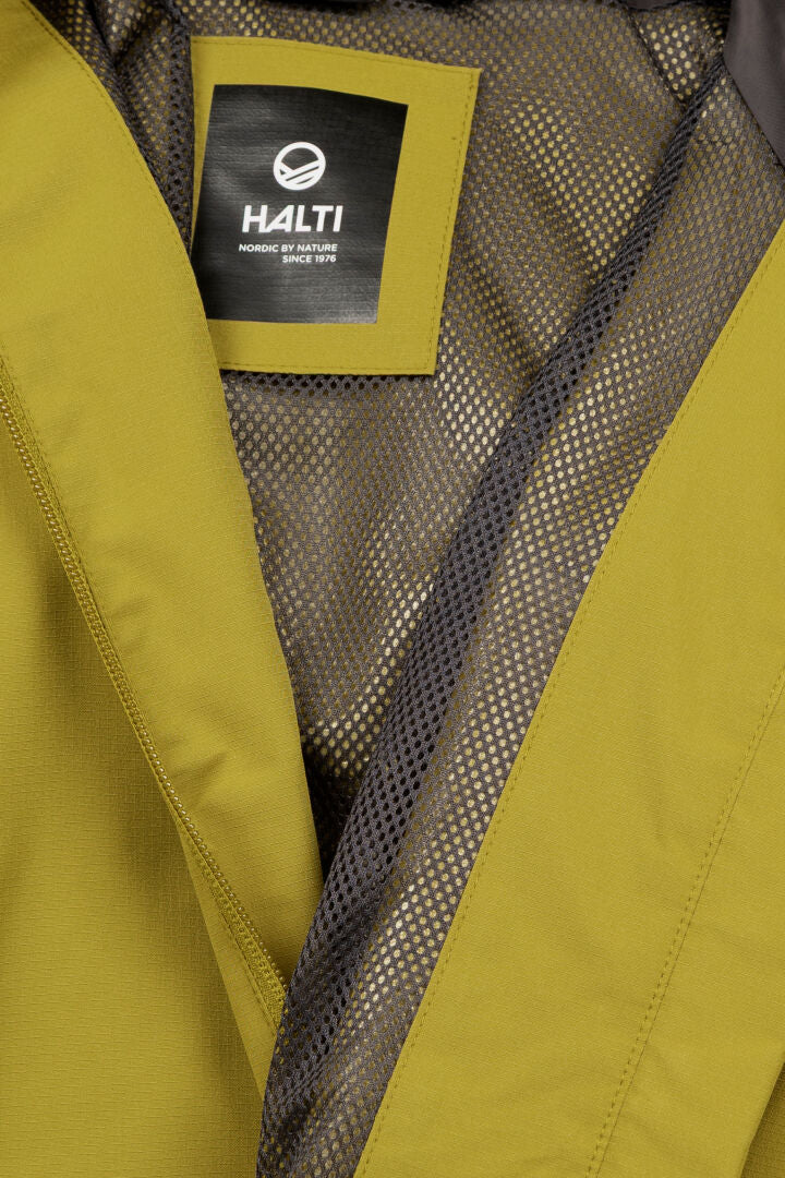 Close-up of Halti Forter DX Shell Jacket Women's in yellow-green, with mesh lining and black Halti label inside.