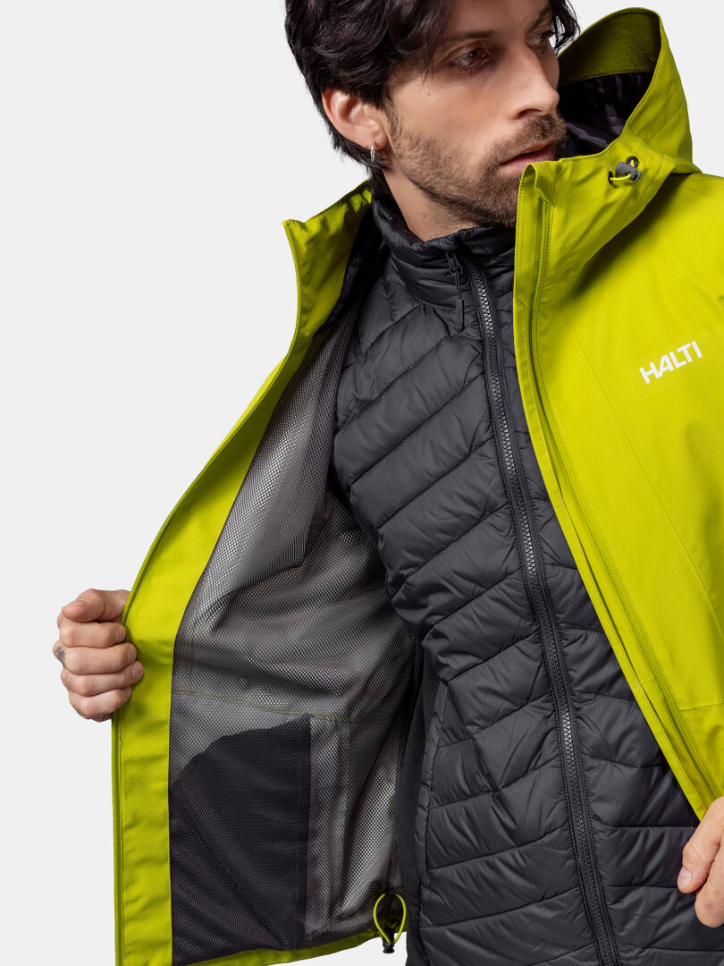 Man wearing a Halti Forter DX Shell Jacket shows off its waterproof lining—ideal for hiking and the outdoors.
