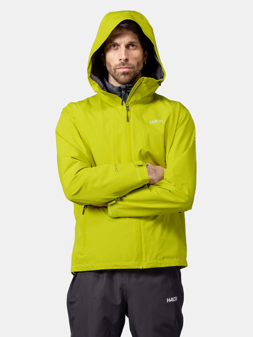 A man in a Halti Forter DX Shell Jacket stands with arms crossed against a plain white background.