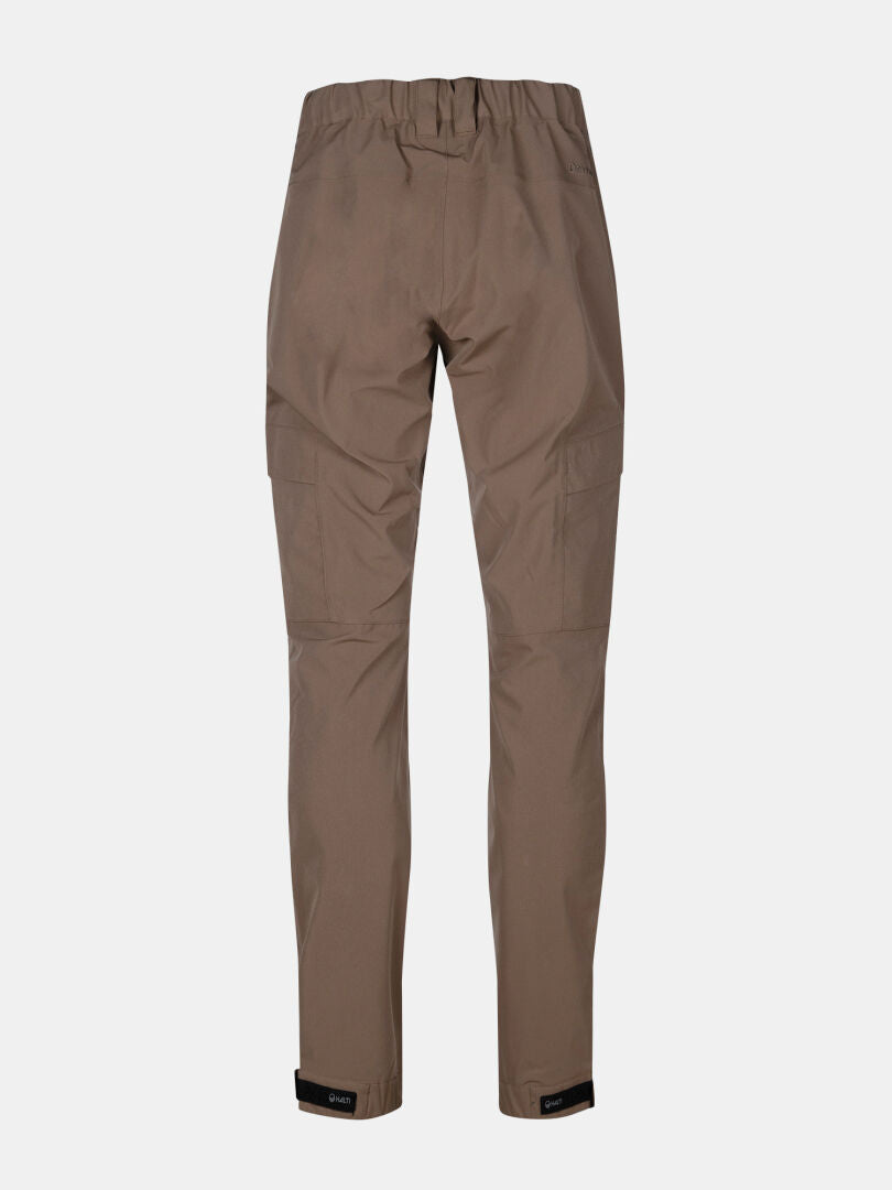 Halti Hiker II DrymaxX womens brown shell pants with elastic waist, side pockets, and adjustable ankle straps shown from back.