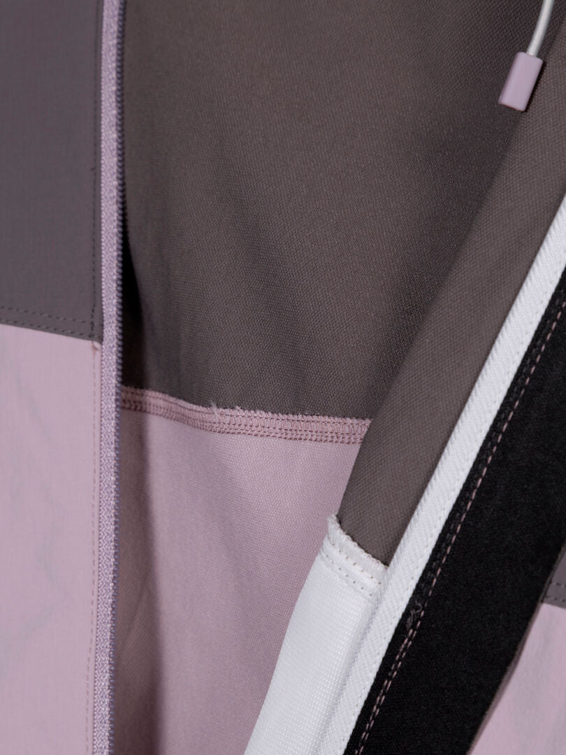 Close-up of Halti Pallas Evo X-stretch Jacket Women's in mauve, gray, lilac & white with visible stitching.