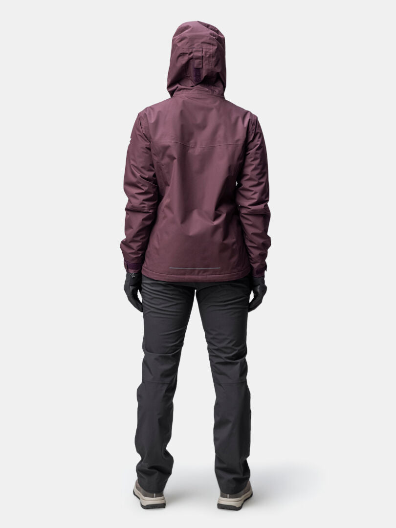 A person in a Halti Forter DX Warm Shell Jacket for women stands facing away against a plain light background.