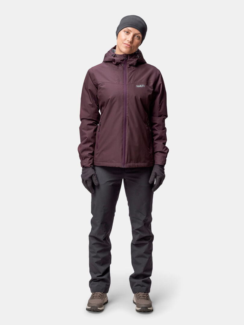 A woman stands facing forward in a Halti Forter DX Warm Shell Jacket against a plain background.