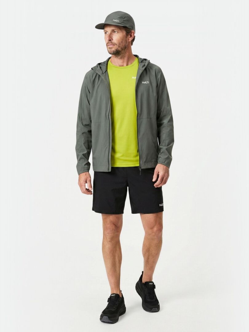 Man wearing Halti Pisarat 2,5L DX Shell Jacket stands against a white background.