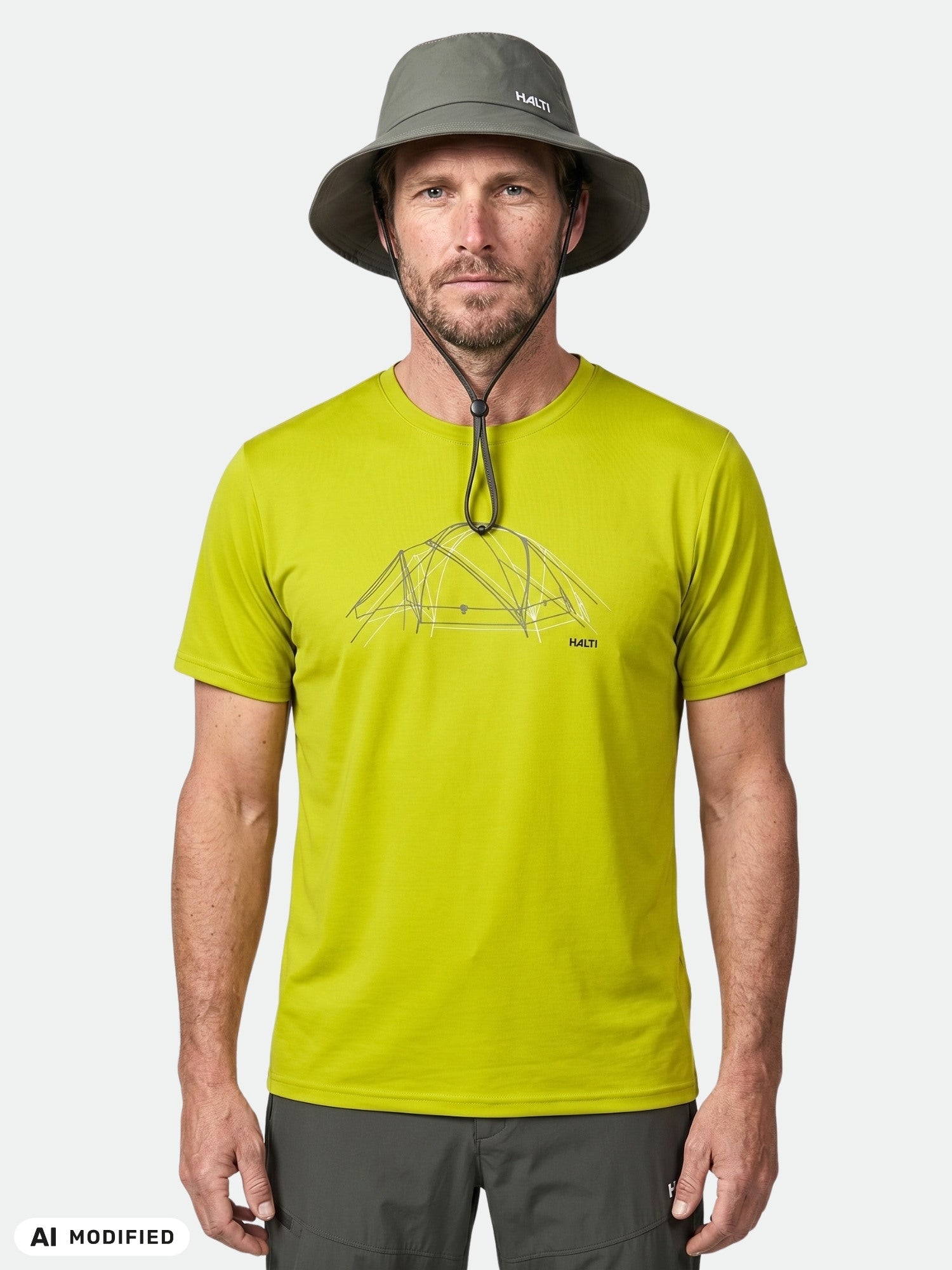 A man wears a Halti Kalteva T-shirt and gray hat, standing facing forward against a plain background.