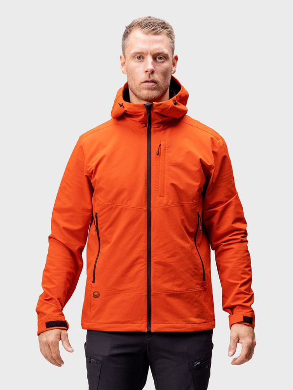 Man wearing Halti Pallas Evo Brushed X-stretch Jacket Men’s in orange with zippered pockets, on a light gray background.