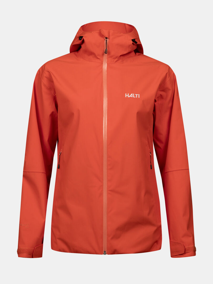 A red-orange Halti Staala DX Shell Jacket Women's with hood and zip pockets, shown on a plain white background.