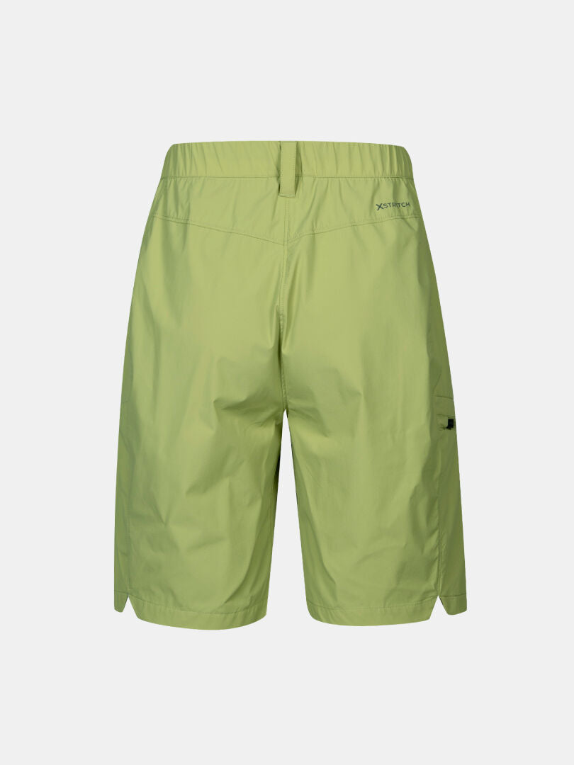 Rear view of Halti Pallas Cool Shorts Women's in light green, featuring an elastic waistband and small logo on right hip.