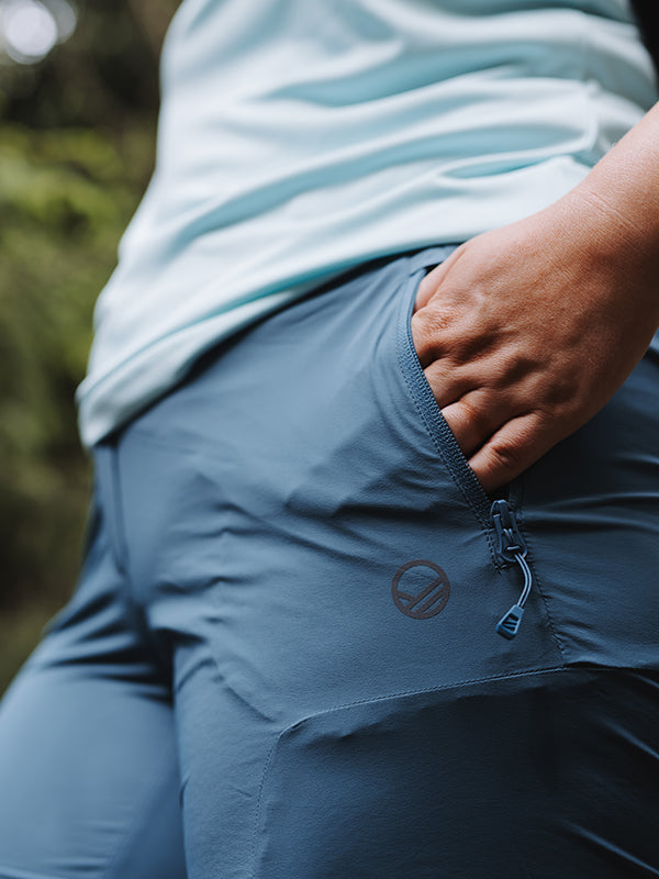 Close-up of Halti Pallas Cool X-stretch Capri Pants Womens Plus, hand in pocket, with a light blue shirt.