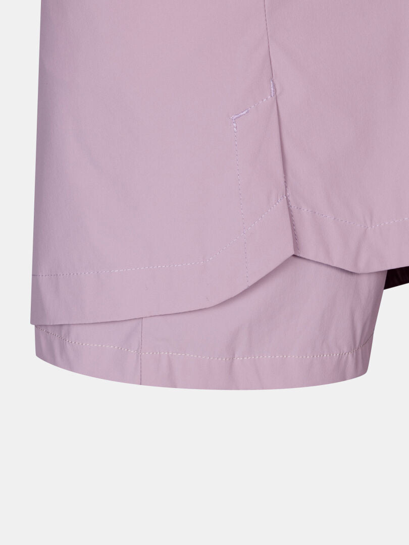 Close-up of the hem and side seam on Halti Pallas Cool Skort Women's in light purple, showing visible stitching.