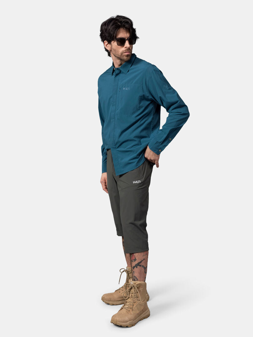 A man in sunglasses wears the Halti Samoy Longsleeve Trekking Shirt Men's against a plain background.
