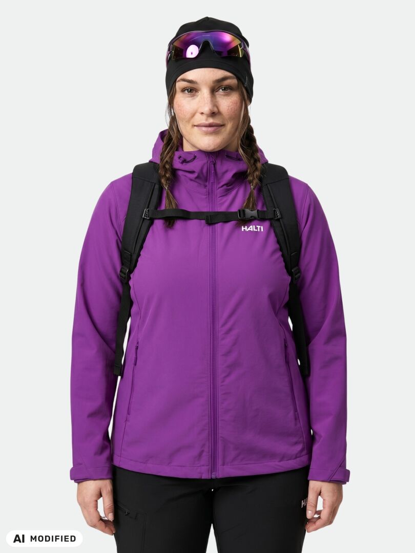 Woman in Halti Finholma X-stretch Plus jacket (purple), black hat, pants, backpack, sunglasses, facing forward.