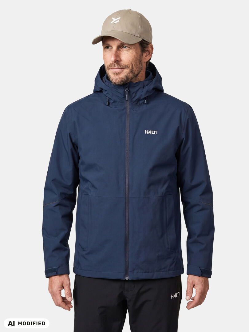 Man wears Halti Loito 3-in-1 DX Jacket, black pants, beige cap, standing against a plain white background.