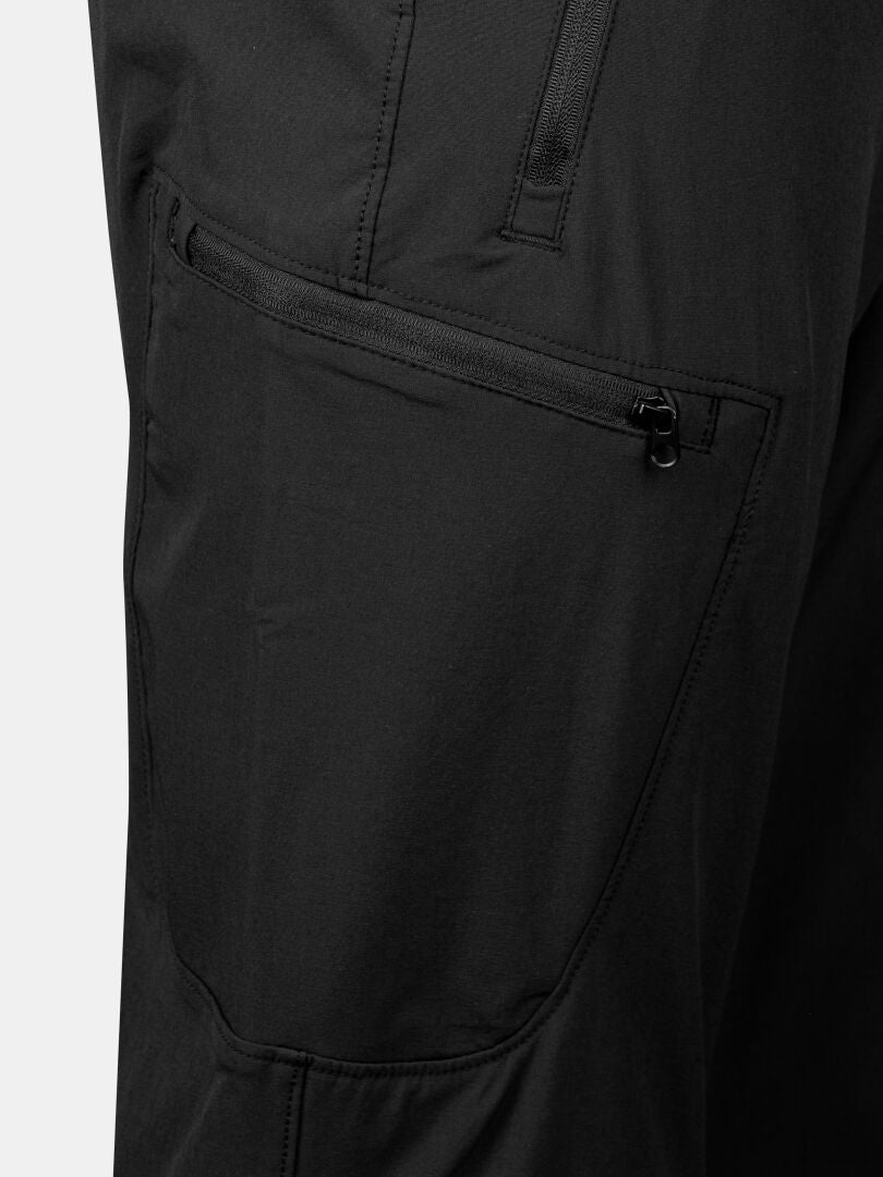 Close-up of black zipper pocket on Halti Pallas X-stretch Outdoor Pants Women's, highlighting stitching and fabric texture.